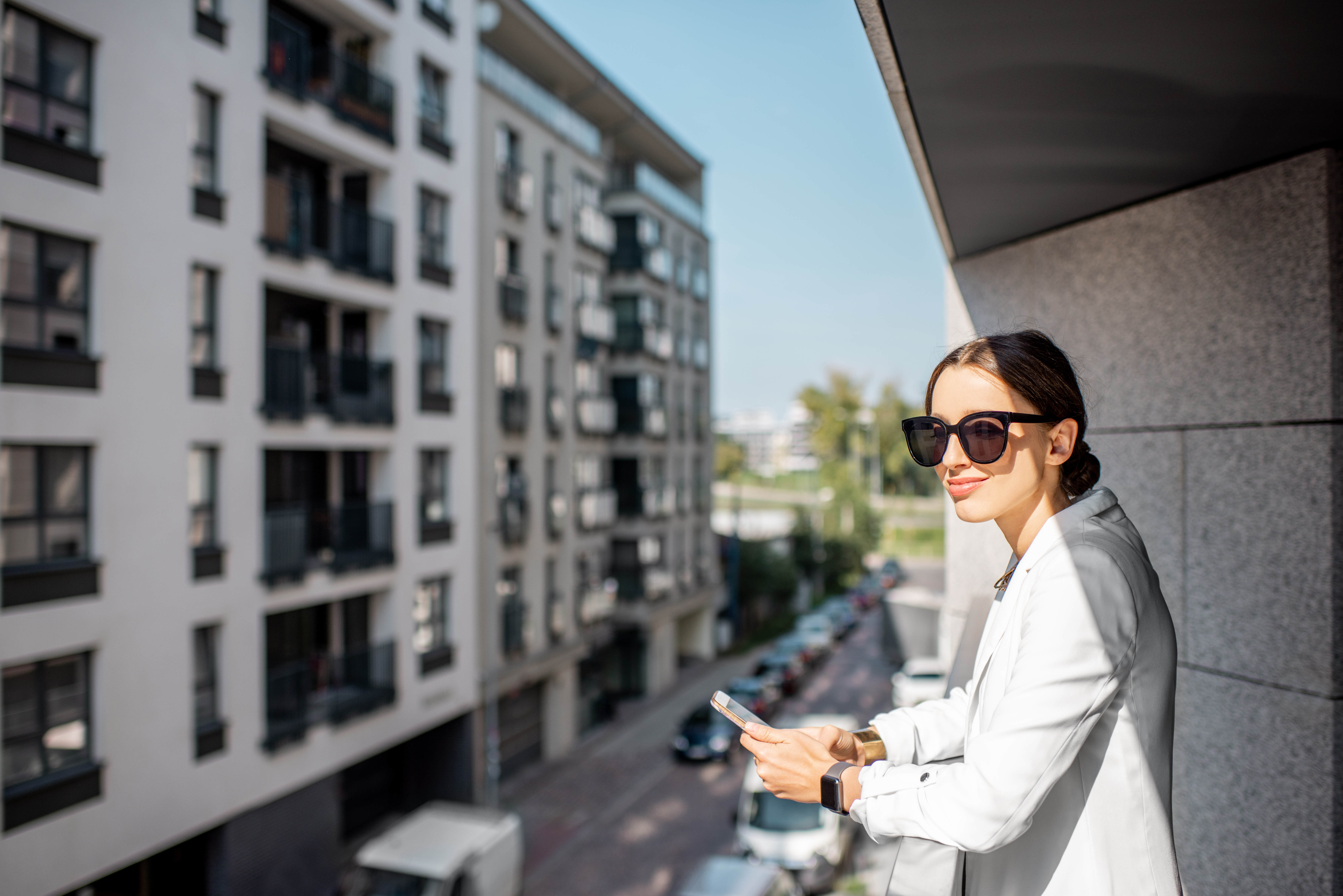 Woman looking out over apartments.